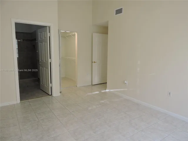 an empty room with closet and a bathroom