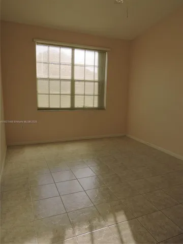 an empty room with a empty space and window