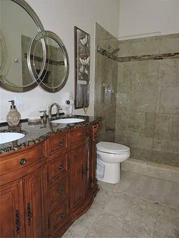a bathroom with a toilet a sink and mirror