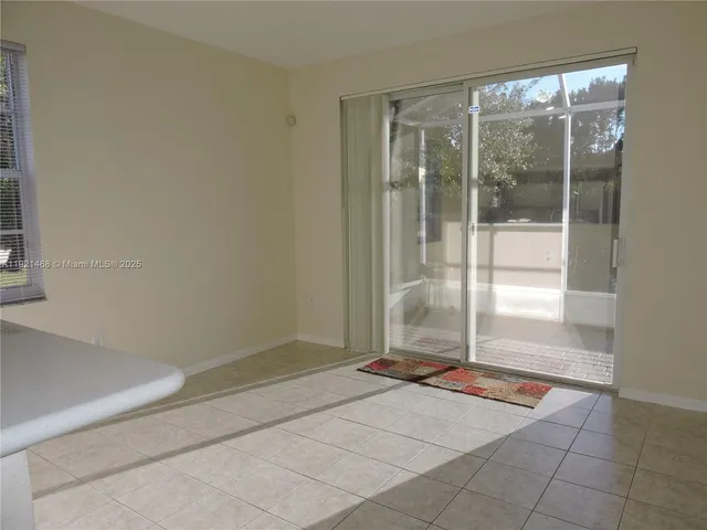 a living room with a glass door shower and a glass door