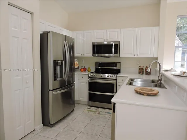 a kitchen with stainless steel appliances a refrigerator stove and microwave