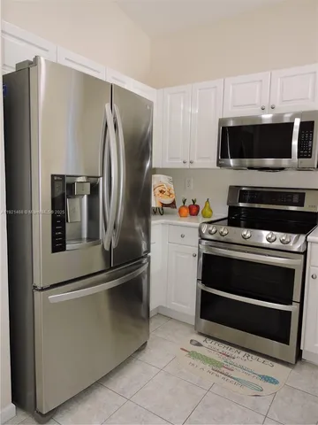 a kitchen with stainless steel appliances and a refrigerator