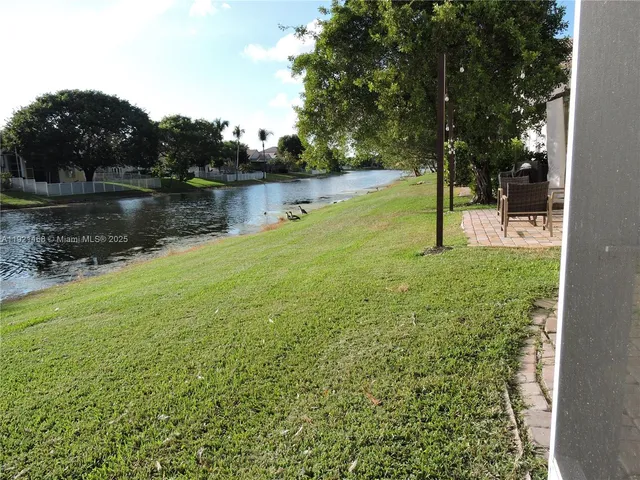 a view of a lake with houses in background