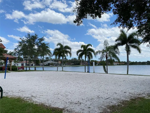 a view of road with palm trees