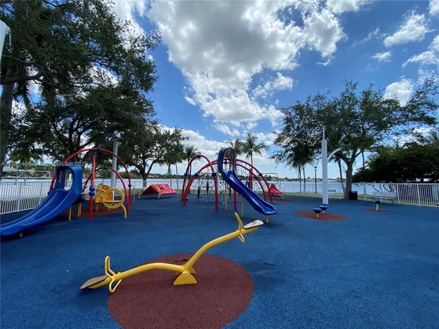 a view of a park with swings and slides