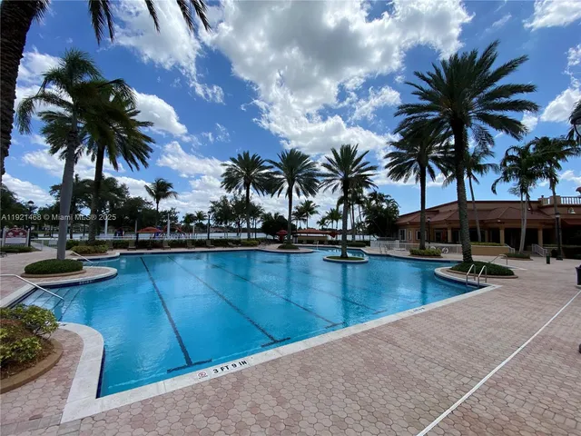 a view of swimming pool with outdoor seating and a potted plants