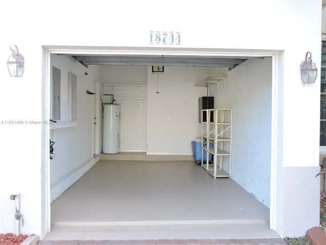 a view of a kitchen with a sink and a refrigerator
