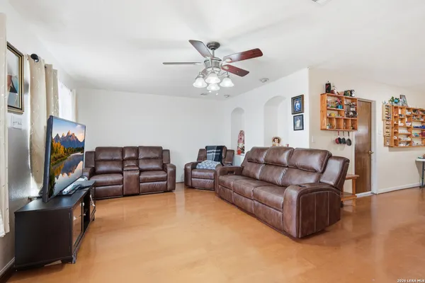 a living room with furniture and a flat screen tv