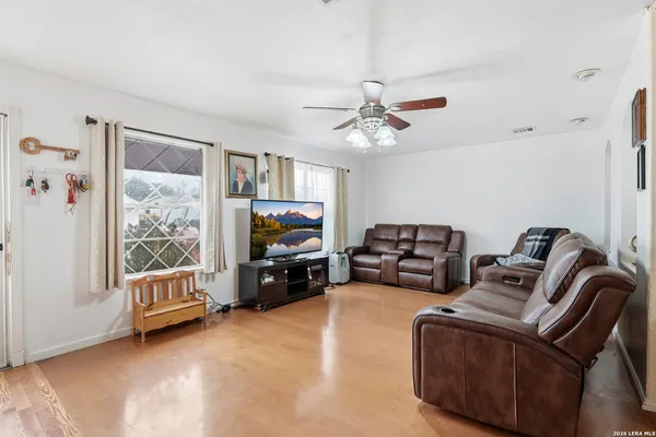 a living room with furniture a flat screen tv and a couch