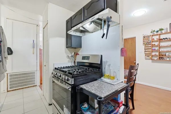 a kitchen with stainless steel appliances granite countertop a stove and a refrigerator