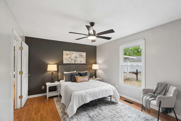 a bedroom with a bed and chair
