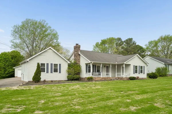 a front view of a house with a garden