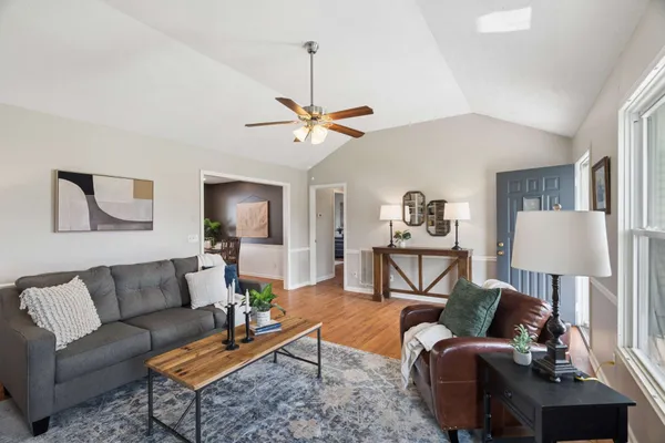 a living room with furniture a lamp and a chandelier