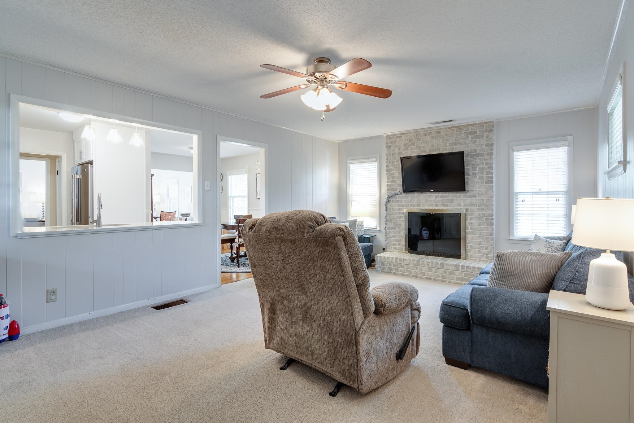 274 Montelo Road Memphis, TN 38120 - Photo 11 of 25 a living room with furniture a fireplace and a flat screen tv