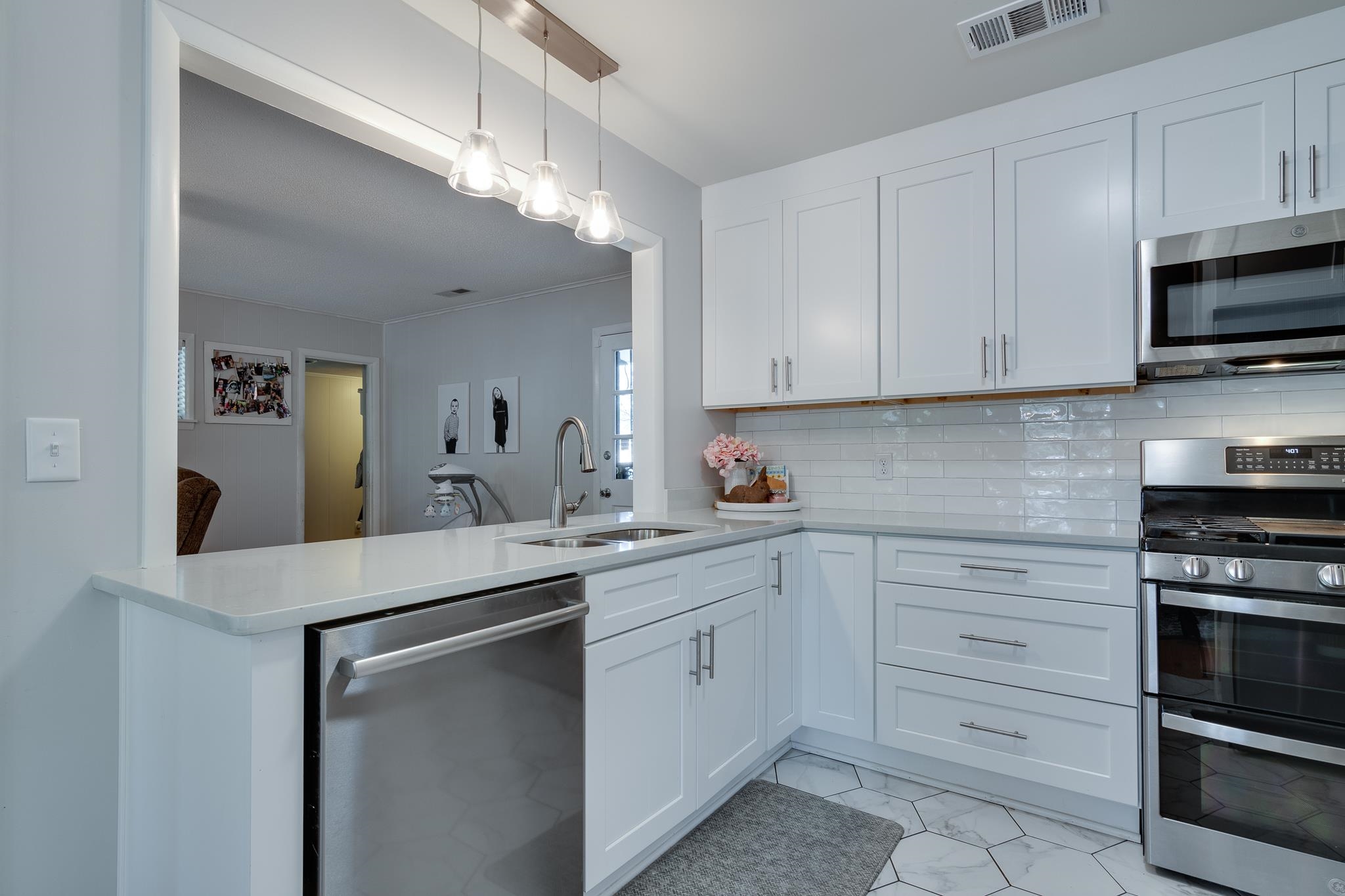 274 Montelo Road Memphis, TN 38120 - Photo 10 of 25 a kitchen with white cabinets and stainless steel appliances