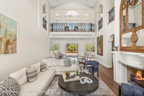 a living room with furniture a fireplace and dining table
