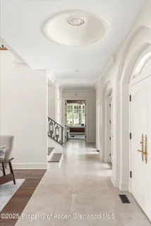 a view of an entryway with wooden floor