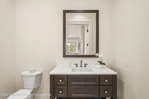 a bathroom with a sink vanity and toilet