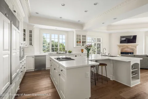 a kitchen with white cabinets and white appliances