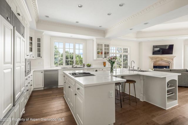a kitchen with white cabinets and white appliances