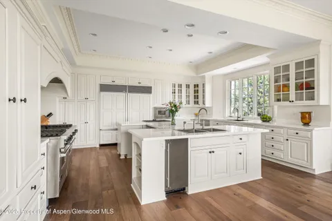 a open kitchen with cabinets a sink and appliances in it