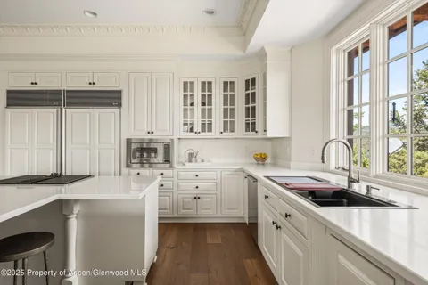 a kitchen with a sink stove top oven and cabinets