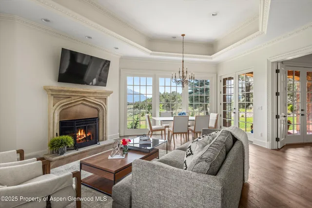 a living room with furniture fireplace and flat screen tv