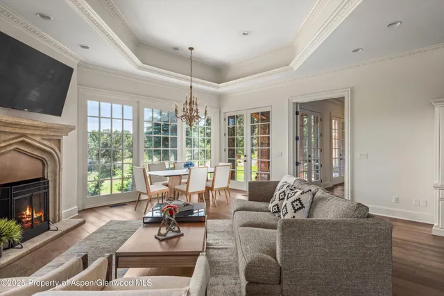 a living room with fireplace furniture and a flat screen tv