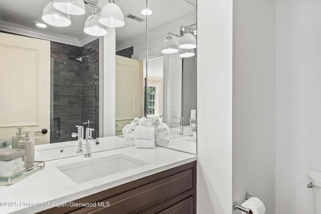 a bathroom with a sink vanity granite and a mirror