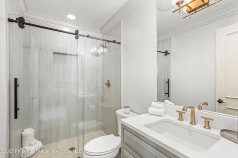 a bathroom with a sink toilet and shower