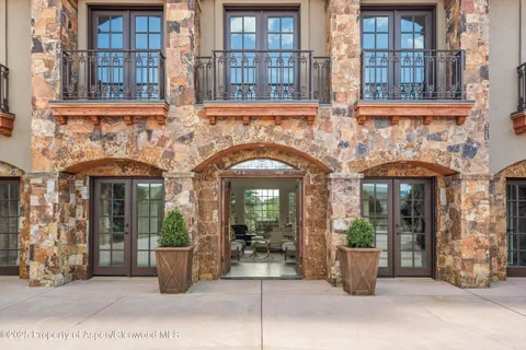 a view of a brick building with potted plants