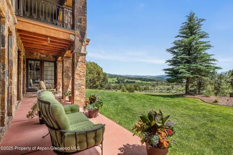 a view of a chair and tables front of the house