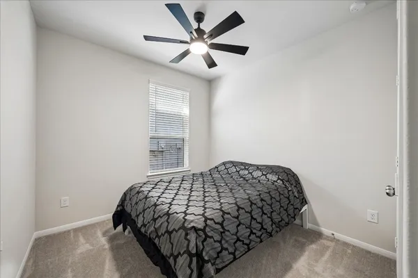 a bedroom with bed and a window