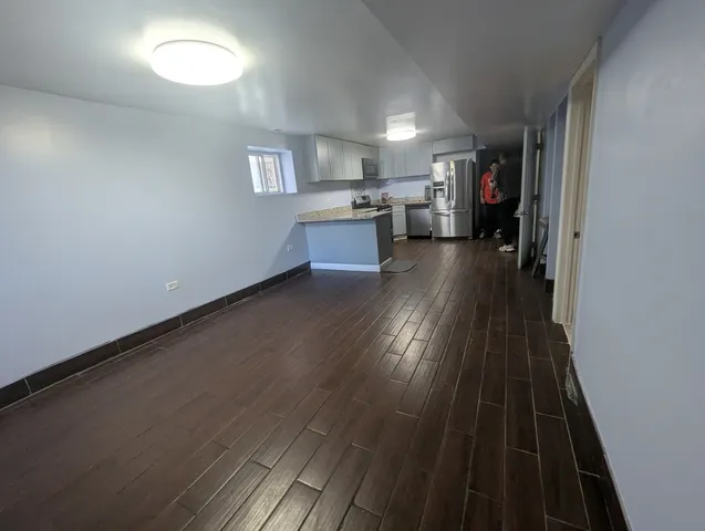 wooden floor in an empty room and a kitchen