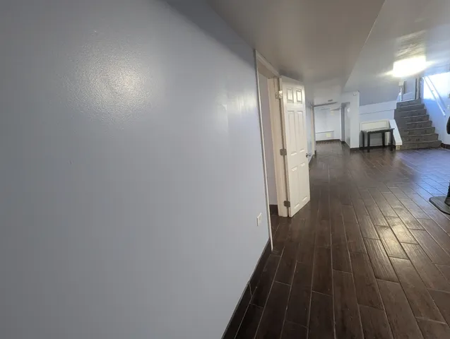 a view of a room with wooden floor and a window