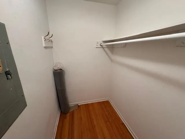 a view of a room with wooden floor and white walls