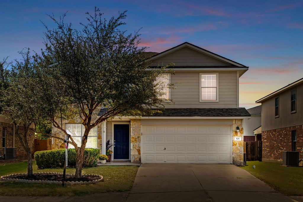 a front view of a house with garage