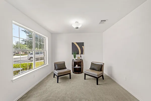 a living room with furniture and a window
