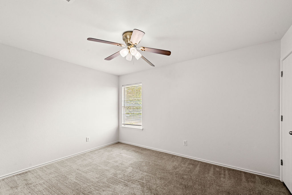525 Meadow Park Drive Georgetown, TX 78626 - Photo 14 of 39 an empty room with a window and a fan