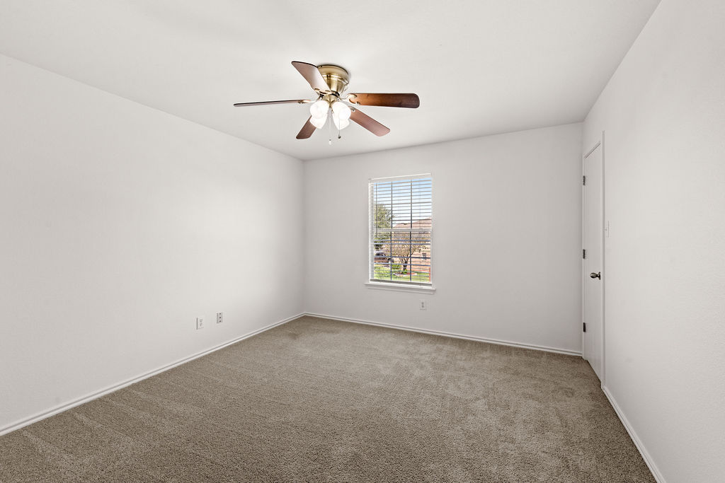 525 Meadow Park Drive Georgetown, TX 78626 - Photo 18 of 39 an empty room with windows and fan