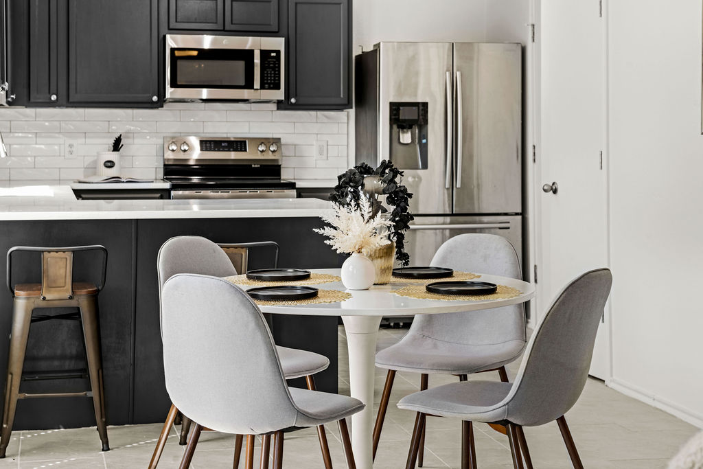 525 Meadow Park Drive Georgetown, TX 78626 - Photo 2 of 39 a kitchen with stainless steel appliances granite countertop a stove top oven a sink a dining table and chairs