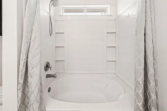 a white bath tub sitting next to a white sink
