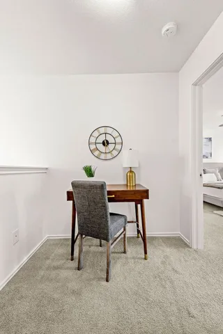 a view of a room with a table and chairs