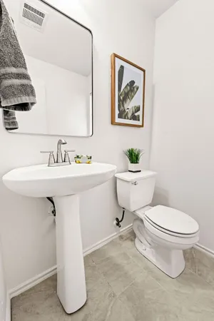 a white toilet sitting next to a bathroom sink
