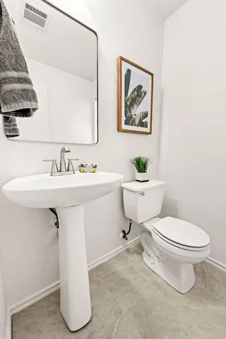 a white toilet sitting next to a bathroom sink