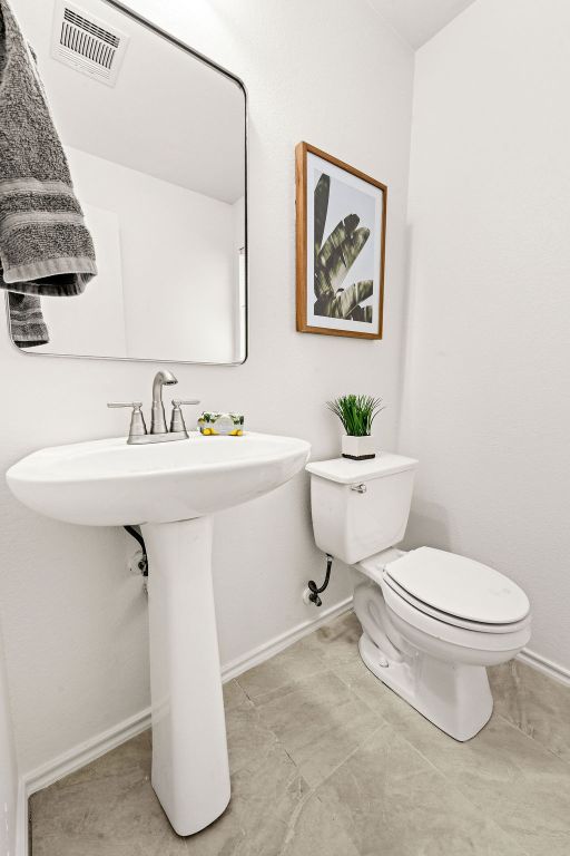 525 Meadow Park Drive Georgetown, TX 78626 - Photo 29 of 39 a white toilet sitting next to a bathroom sink