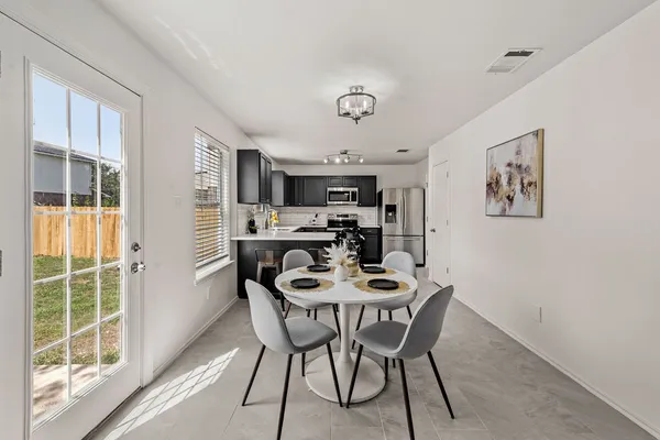 a view of a dining room with furniture window and outside view