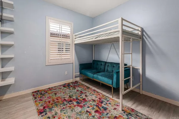 a bedroom with a bunk bed and a window