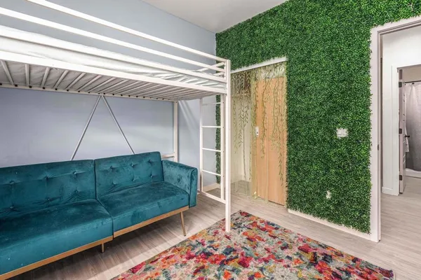 a bedroom with a bed and a window