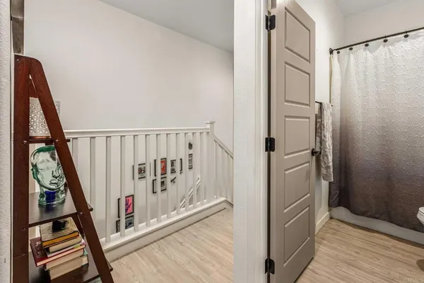 a view of a hallway with wooden floor and staircase